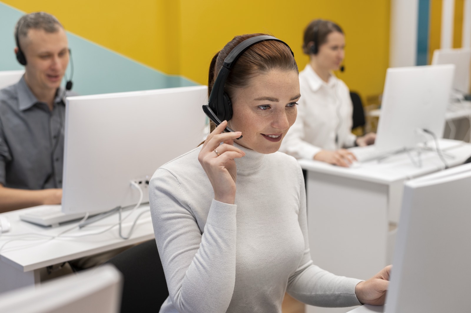 An interviewer on a headset talking with a respondent